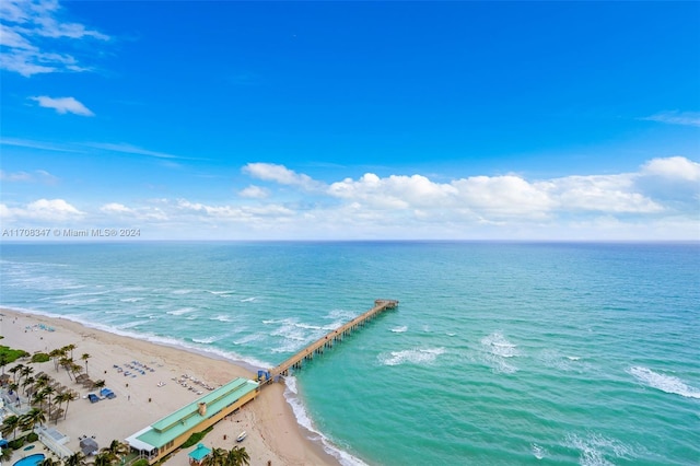 drone / aerial view with a water view and a beach view