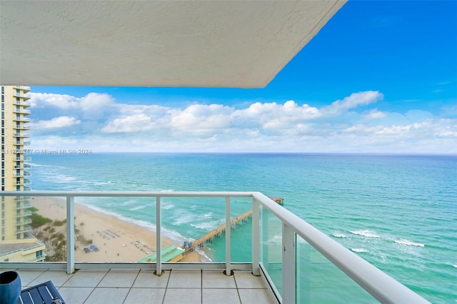 balcony featuring a water view and a view of the beach