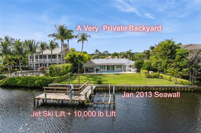 dock area featuring a lawn and a water view