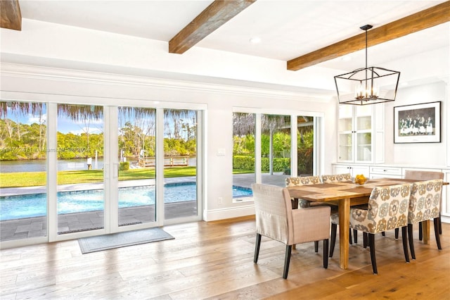 sunroom with beamed ceiling, a chandelier, and plenty of natural light