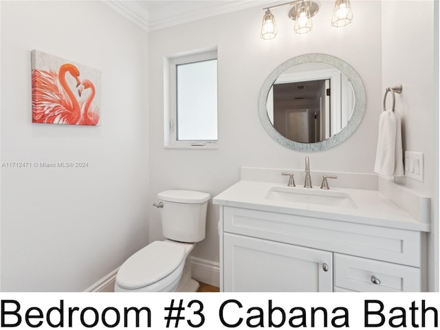 bathroom featuring vanity, toilet, and ornamental molding