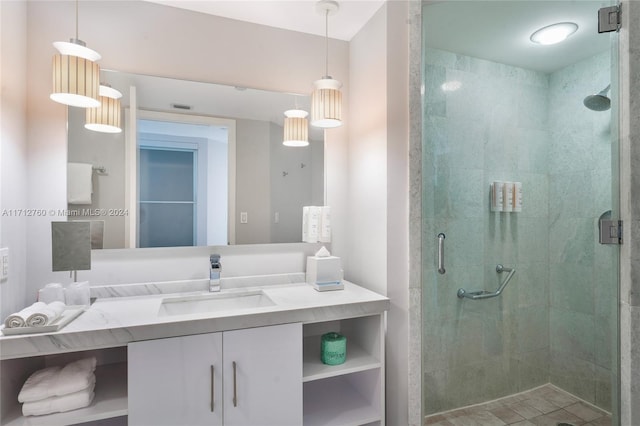 bathroom featuring vanity and a shower with shower door