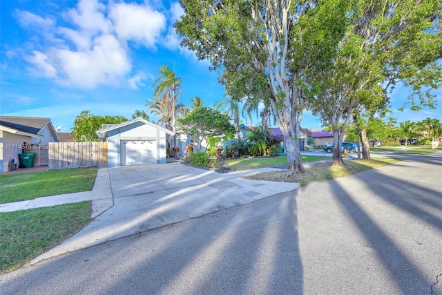 view of front of property with a front yard and a garage