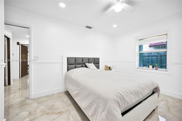 bedroom featuring ceiling fan and ornamental molding