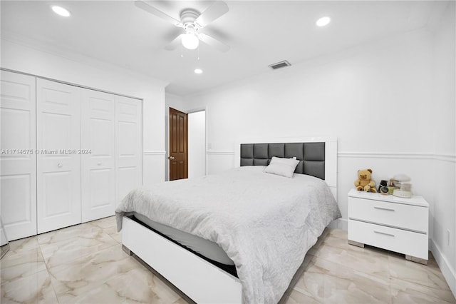 bedroom with a closet, ceiling fan, and crown molding