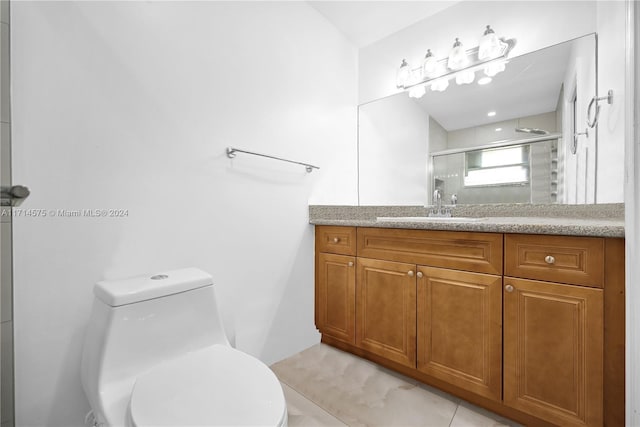 bathroom with tile patterned floors, vanity, toilet, and walk in shower