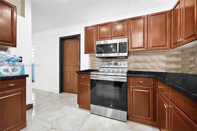 kitchen with tasteful backsplash, dark stone countertops, and stainless steel appliances