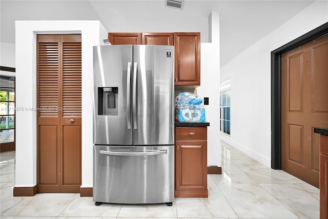 kitchen with stainless steel fridge with ice dispenser and backsplash