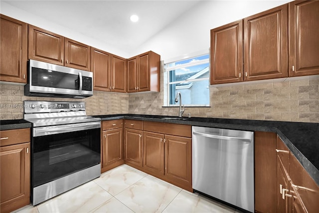 kitchen with backsplash, sink, and stainless steel appliances