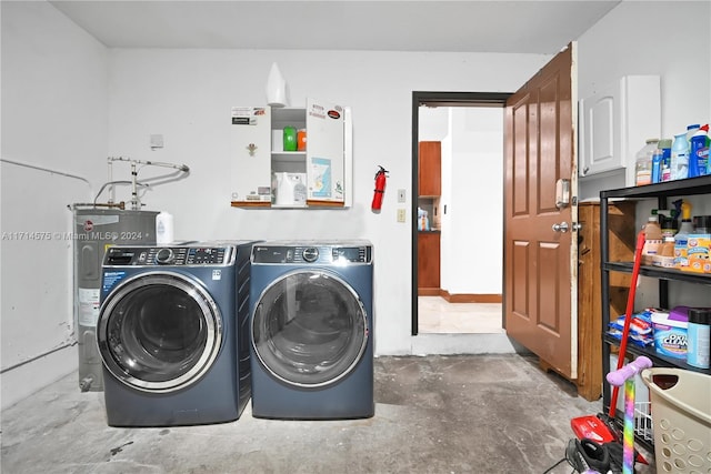 laundry area featuring washing machine and dryer and electric water heater