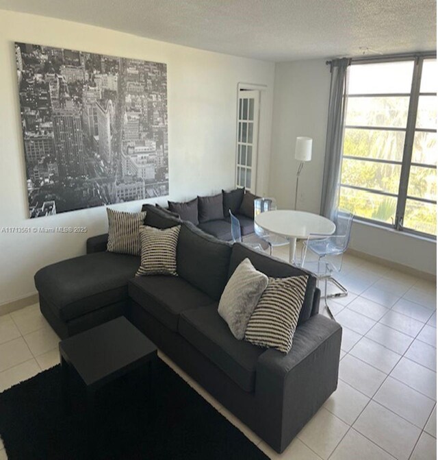 tiled living room with a textured ceiling