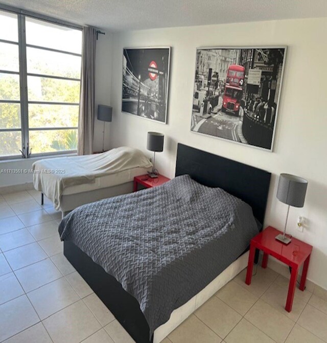 bedroom with light tile patterned floors and a textured ceiling