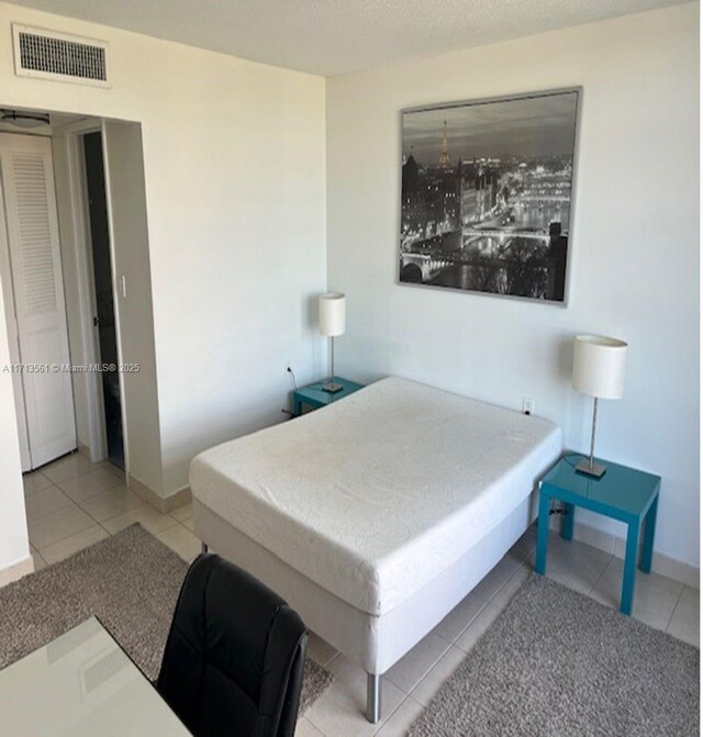 bedroom featuring light tile patterned flooring