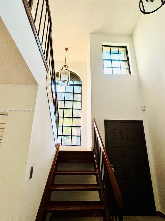 staircase featuring baseboards