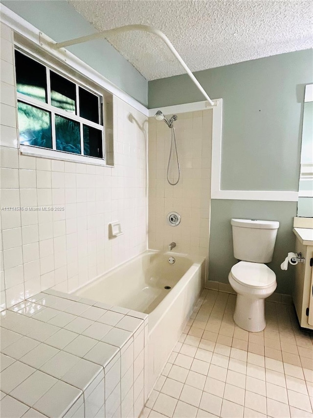 bathroom featuring toilet, a textured ceiling, vanity,  shower combination, and tile patterned floors