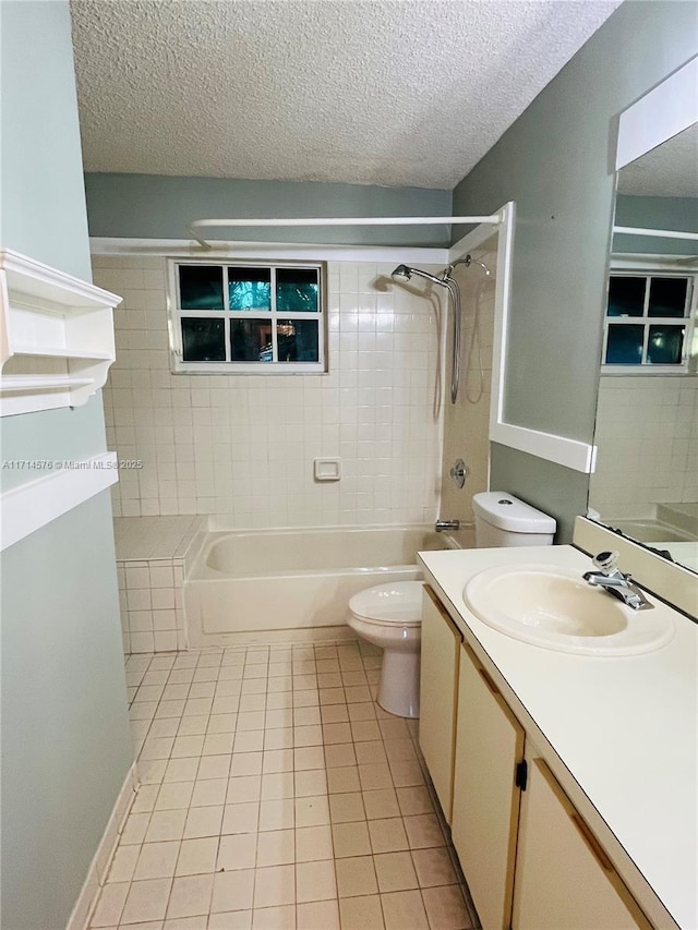 bathroom featuring toilet, tile patterned flooring, a textured ceiling, and vanity