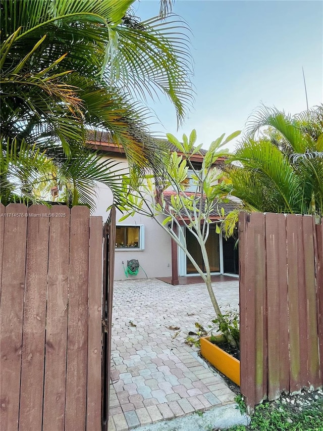 view of gate featuring a patio and fence