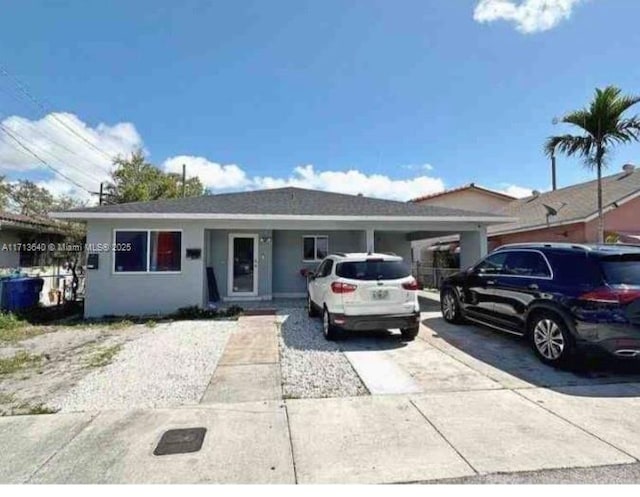 single story home featuring a carport