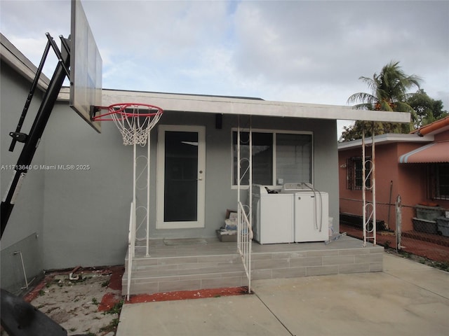 entrance to property featuring washing machine and clothes dryer