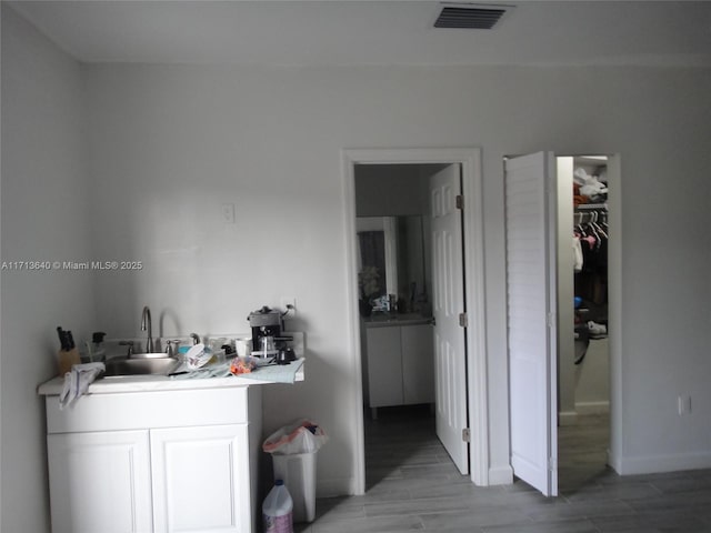 bathroom with vanity and wood-type flooring