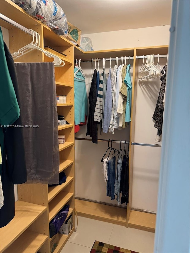 walk in closet featuring light tile patterned flooring