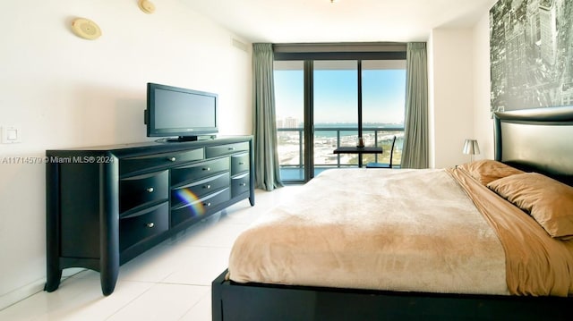 bedroom with access to outside, light tile patterned floors, and a wall of windows