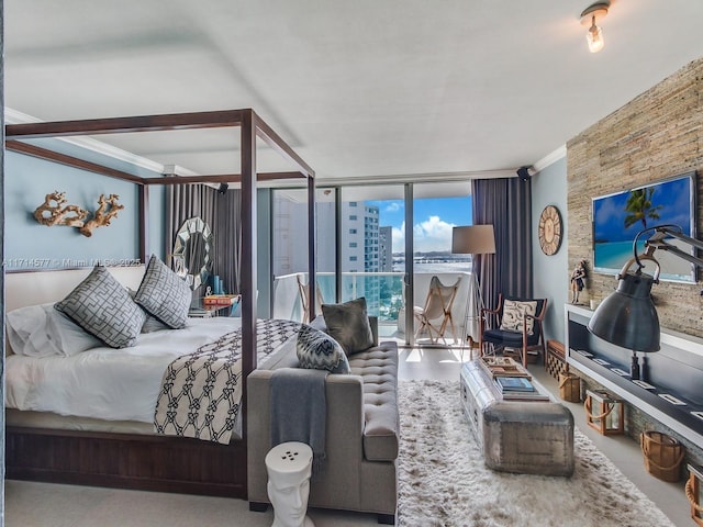 bedroom featuring crown molding and access to exterior