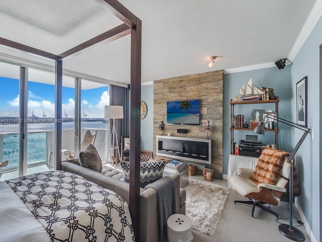 bedroom featuring floor to ceiling windows, a large fireplace, crown molding, and access to exterior