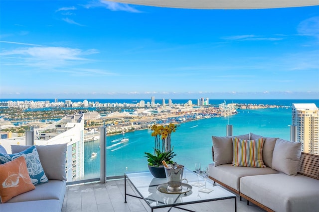 balcony with a water view and an outdoor hangout area