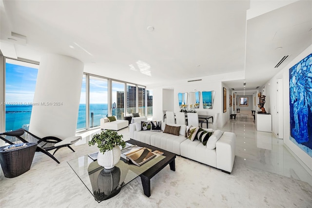 living room with a water view and a wall of windows