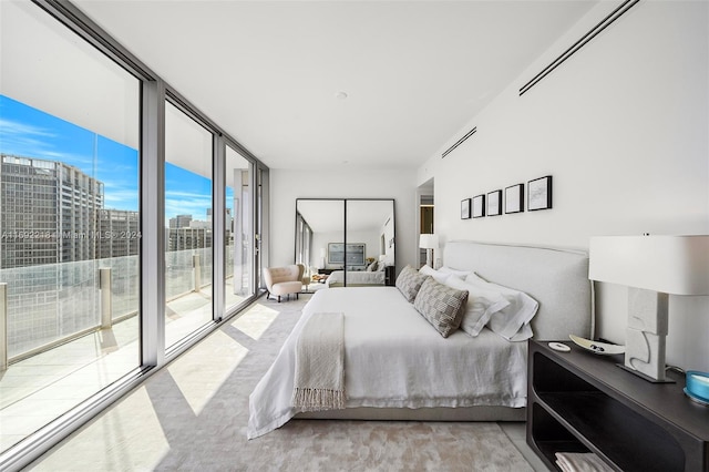 bedroom with access to outside and expansive windows