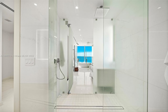 bathroom with tile patterned floors and a shower with door