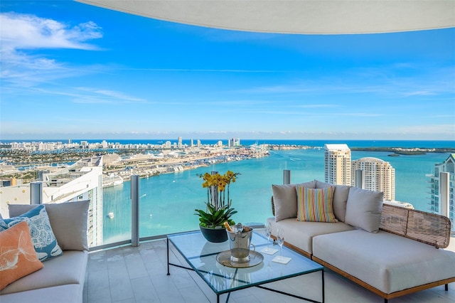 balcony featuring a water view and an outdoor hangout area