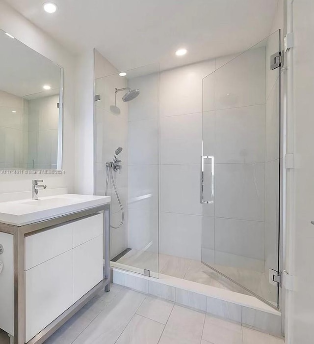 bathroom with tile patterned floors, vanity, and a shower with shower door