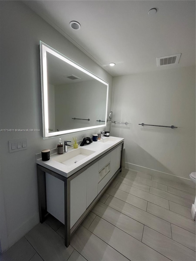 bathroom with tile patterned floors, vanity, and toilet