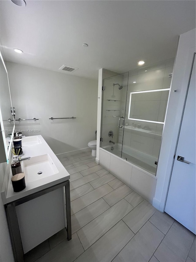 full bathroom with tile patterned floors, vanity, toilet, and enclosed tub / shower combo