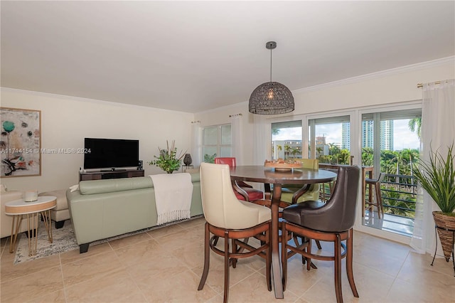 tiled dining room featuring ornamental molding