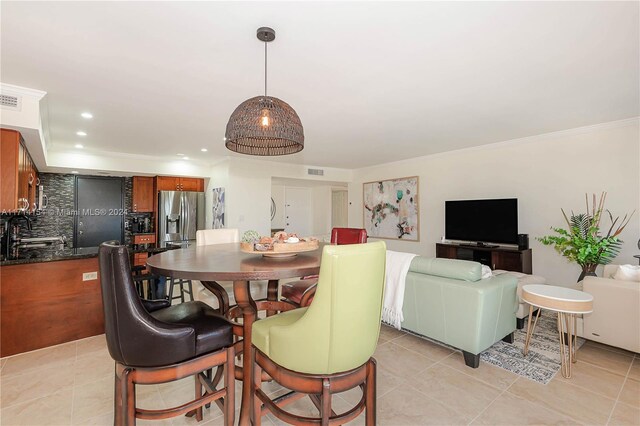 tiled dining room with crown molding