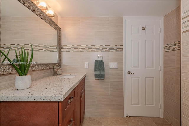 bathroom featuring tile patterned floors, vanity, and tile walls