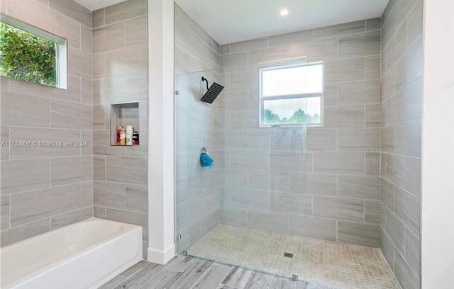 bathroom featuring plus walk in shower