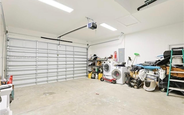 garage with washing machine and dryer and a garage door opener