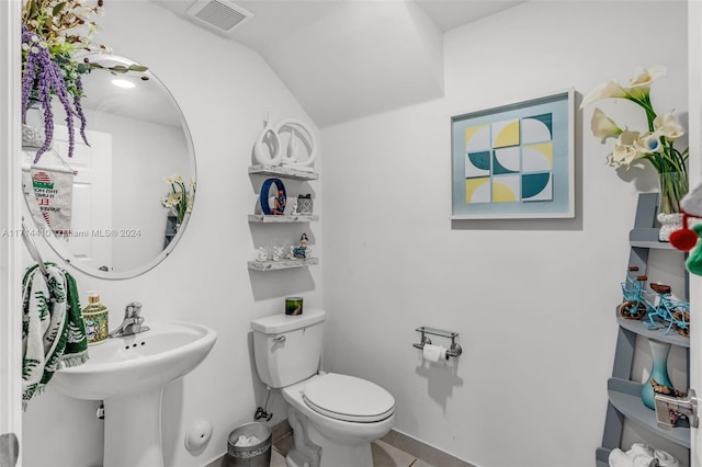 bathroom featuring tile patterned floors, toilet, lofted ceiling, and sink