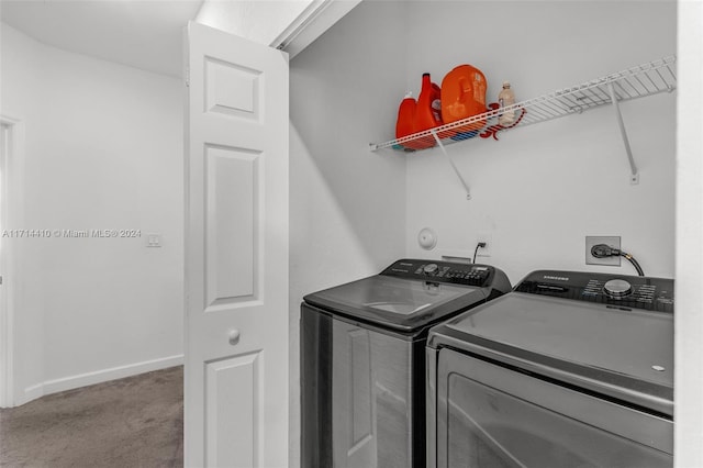 laundry room featuring washing machine and dryer and carpet