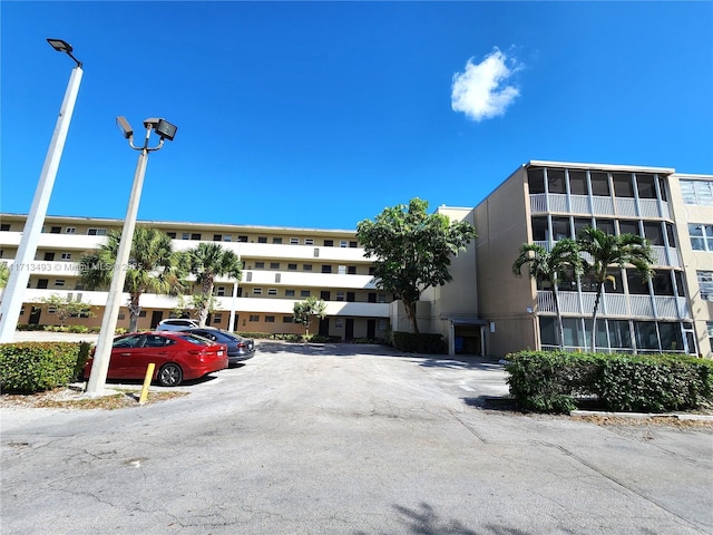 view of building exterior with uncovered parking