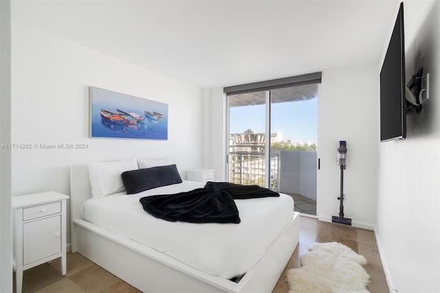 bedroom featuring access to outside and expansive windows