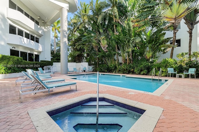 view of swimming pool with a community hot tub and a patio