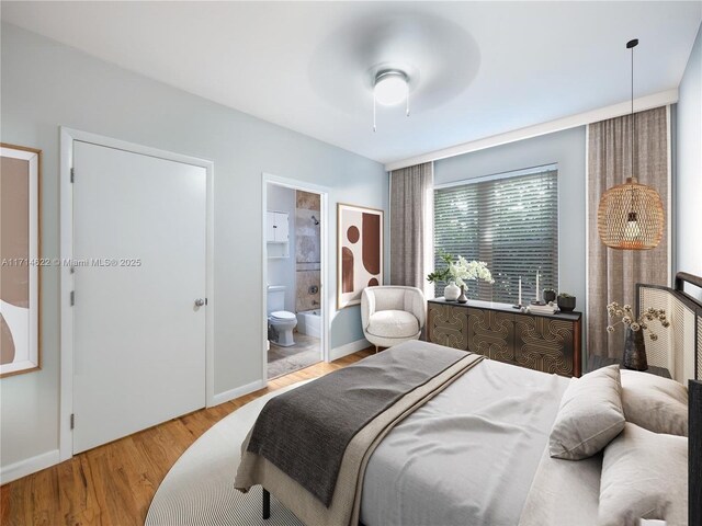 bedroom featuring ceiling fan, a closet, and hardwood / wood-style flooring