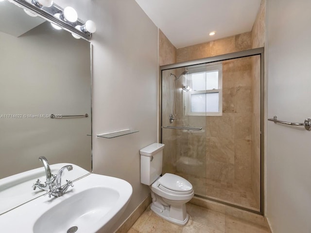 bathroom with sink, toilet, and walk in shower