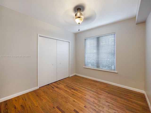 1018 Meridian Ave Unit 4, Miami Beach, FL 33139 - unfurnished bedroom featuring a closet, wood finished floors, baseboards, and ceiling fan