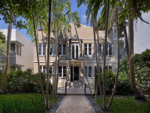 1018 Meridian Ave Unit 4, Miami Beach, FL 33139 - view of front of home featuring stucco siding, a balcony, and entry steps